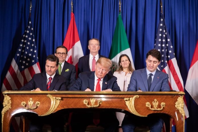 Enrique Peña Nieto, Donald Trump, and Justin Trudeau signing the United States–Mexico–Canada Agreement in 2018