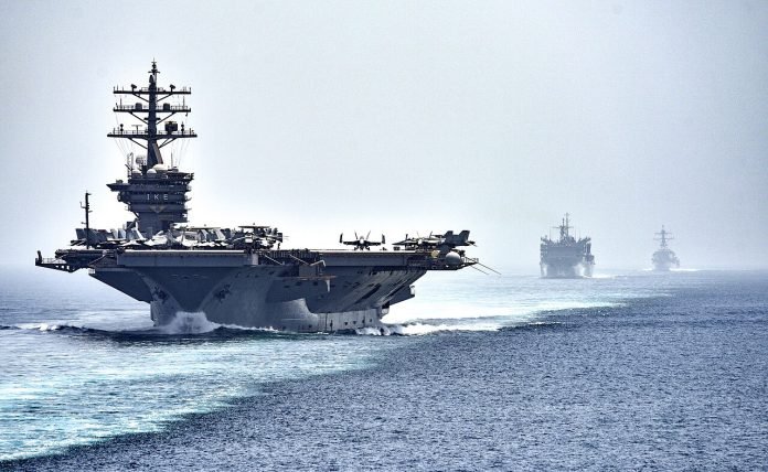 1280px-CVN_69_transits_the_Strait_of_Hormuz_(28465403076)