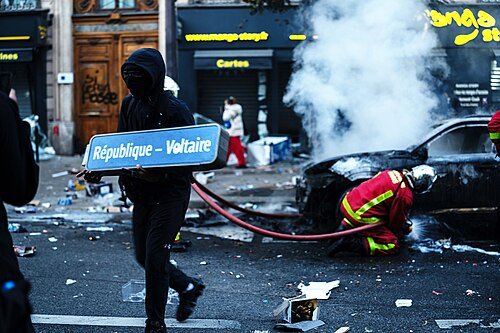 Paris_riots_17_October_2026_Man_holding_a_République_–_Voltaire_sign_JJxFile_0072_vcontrast